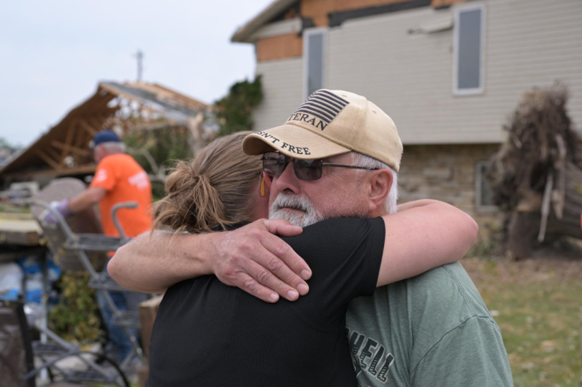Don Wilson, a retired Navy veteran in Menasha now missing the side of his house, hugs Joni Byker, director of Disaster Relief for Samaritan's Purse. Wilson said having the Samaritan's Purse volunteers help him was