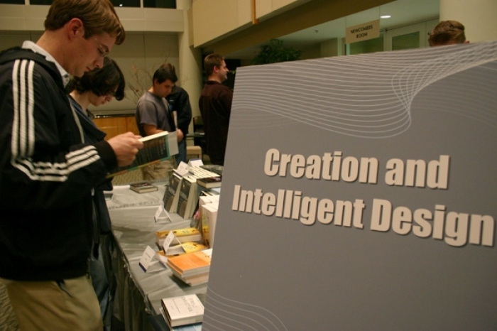 Conference attendants browse through tables of resources on Creation and Intelligent Design at an apologetics conference at McLean Bible Church.