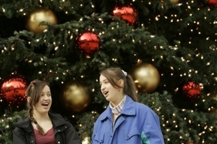 Credit : Gabrielle Reinecke, left, and her twin sister, Adriana, sing the Christmas carol 'Silent Night' at Union Square in San Francisco, Wednesday, Dec. 20, 2006. The two sisters were among a group of St. Ignatius High School students who had taken choir classes