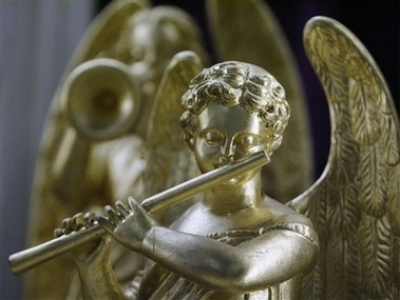 A 19th century hand-carved wooden angel is on display on the altar of Holy Family Catholic Church Saturday, Dec. 23, 2006 in Chicago after two years of restoration and gilding with 23-carat gold leaf.