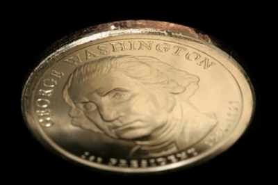 In this undated photo released by Professional Coin Grading Service, a George Washington dollar coin missing the edge inscription is shown. 