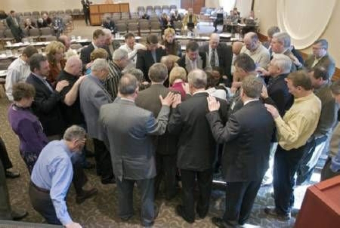 NAMB trustees gather in prayer for Geoff Hammond and his wife, Debbie. Trustees unanimously approved Hammond as NAMB's new president in a March 21 meeting. 