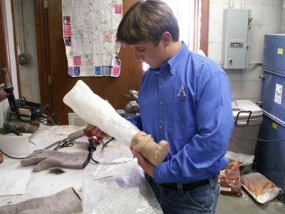 Grayson Rosenberger, grand prize winner of the Sealed Air Corp.'s inaugural Bubble Wrap Competition for Young Inventors, using Bubble Wrap to make a cosmetic covering for a prosthetic leg.