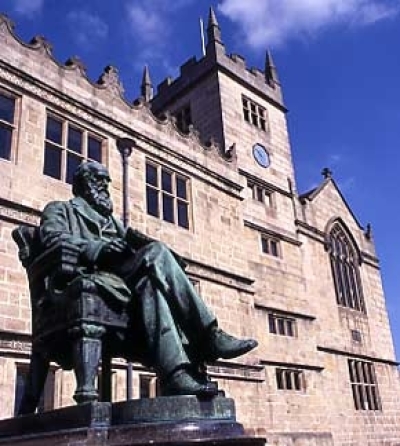 A statue of Charles Darwin stands in front of the Elizabethan building which was in Darwin's time Shrewsbury School, and the school he attended as a boarder, and which is now Shrewsbury's library.