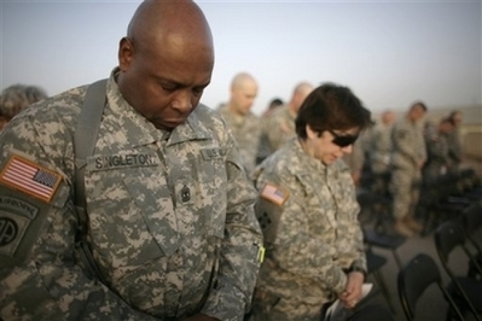U.S. soldiers pray as they celebrate Easter with a sunrise service at Camp Victory, in Baghdad, Iraq, Sunday, March 23, 2008.