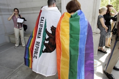 Gay rights supporters wear a California state flag,left, and a gay pride flag outside of the California State Supreme Court building in San Francisco, Thursday, May 15, 2008, after the Court ruled in favor of the right of same sex couples to wed.