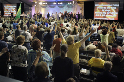 A large crowd gathers and raises their arms as they listen to Todd Bentley lead a revival service in Lakeland, Fla., Thursday, June 12, 2008.