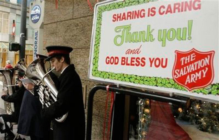 In this Dec. 9, 2008 file photo, the Salvation Army Band performs during the charity's annual holiday fundraising drive in downtown Seattle. The motivations may vary, but the goal is the same: to spread good cheer and good works at the same time by giving 'gifts' to friends and family that are actually donations to charity made in their names.