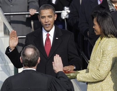 Barack Obama, left, joined by his wife Michelle, takes the oath of office from Chief Justice John Roberts to become the 44th president of the United States at the U.S. Capitol in Washington, Tuesday, Jan. 20, 2009.