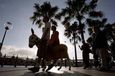 21-year-old drama student Matt Johnson, second left, rides a donkey as he plays Jesus as a procession of members from Wesley Mission march through Circular Quay in Sydney, Australia, Sunday, April 5, 2009. Palm Sunday is the Sunday before Easter when Christians remember how Jesus rode into Jerusalem on a donkey.