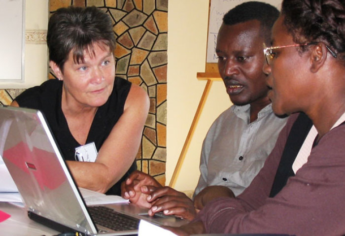Kathie Watters (far left), developer of Wycliffe Bible Translators' AIDS program and co-author of AIDS education shell booklets known as Kande's Story, works with a translation team in this undated file photo.