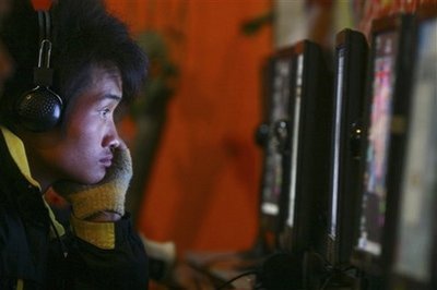 In this Feb. 1, 2009 file photo, a man uses computer at an internet cafe in Fuyang, central China's Anhui province.