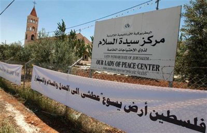 A sign with Arabic writing 'Palestine the land of Jesus is eager for justice, peace and stability' is seen at the Lady of Peace church.