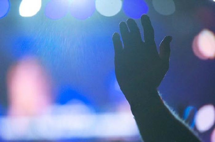 A worshiper lifts his hand during the Hillsong '09 Conference in Sydney, Australia, on Tuesday, July 7, 2009.