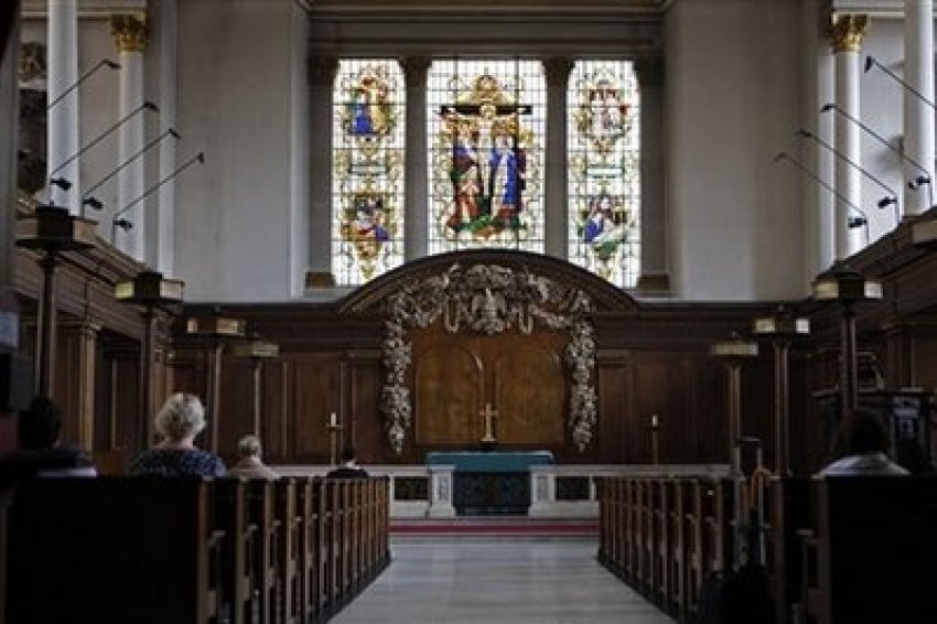People pray inside St James's Church at Piccadilly in central London, Thursday, July 23, 2009.