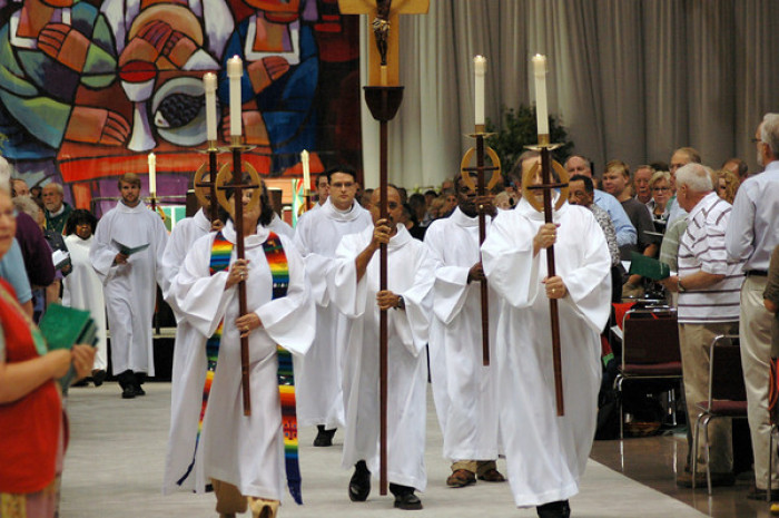 Clergy with the Evangelical Lutheran Church in America carry candles down an aisle in this undated file photo. 
