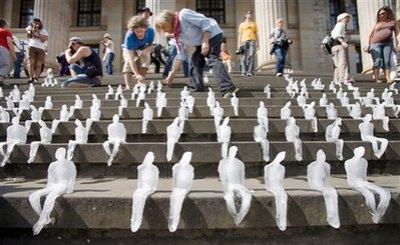 Small ice figures are seen on the stairs of Gendarmenmarkt in Berlin, Germany, Wednesday, Sept. 2, 2009, as part of an art project by World Wide Fund for Nature (WWF). One thousand ice figures by Brasilian artist Nele Azevedo were melting within 30 minutes symbolizing the effect of global warming. 