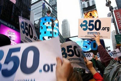 Signs are raised by participants in an International Day of Climate Action rally Saturday Oct. 24, 2009 in New York's Times Square. The number 350 represents what some scientists say is the most carbon dioxide in parts per million we can safely have in the atmosphere.