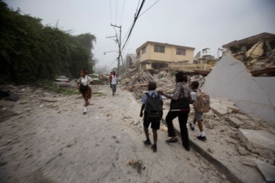 People walk through the streets after a powerful earthquake struck Port-au-Prince, Tuesday, Jan. 12, 2010.
