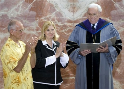 Sheila Schuller Coleman and her husband, Jim, left, share applause with congregants at the Crystal Cathedral in Garden Grove, Calif., as her father Robert H. Schuller, names her senior pastor over the church he led for 55 years, on Sunday July 11, 2010.