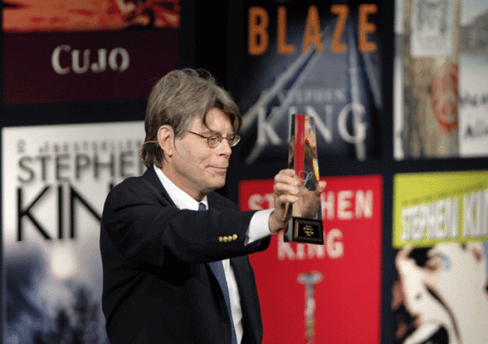 Best-selling author Stephen King holds his lifetime achievement award from the Canadian Booksellers Association in Toronto, Friday, June 8, 2007.