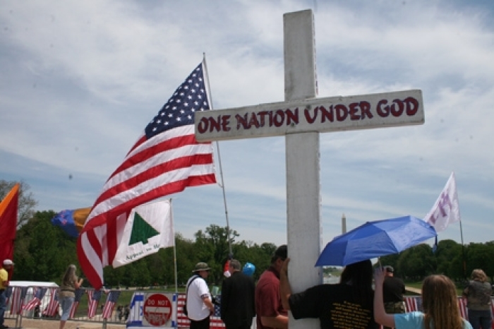 In this file photo, a cross and the American flag are held up during a rally in Washington, D.C., May 2010.