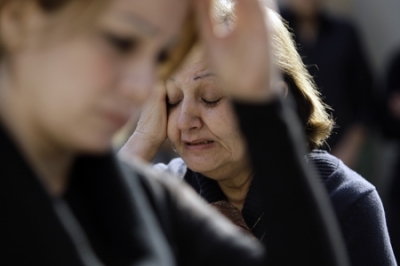In this photo taken on Dec. 10, 2010, Christians grieve during Mass at Our Lady of Salvation church in Baghdad, Iraq. 
