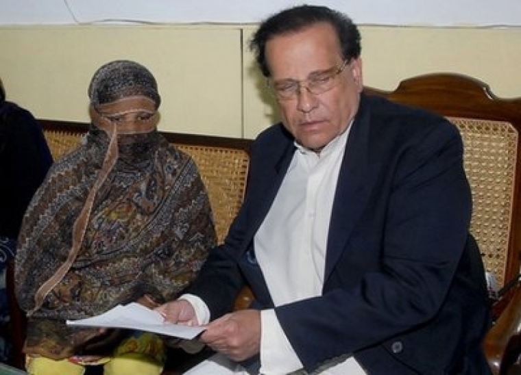 In this Nov. 20, 2010 file photo, Salman Taseer, right, Governor of Pakistani Punjab Province, listens to Pakistani Christian woman Asia Bibi, left, at a prison in Sheikhupura near Lahore, Pakistan. Taseer was shot dead Tuesday, Jan. 4, 2011, by one of his guards in the Pakistani capital, apparently because he had spoken out against the country's controversial blasphemy laws, officials said.