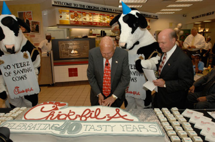 Atlanta-based restaurant chain Chick-fil-A celebrated its 40th anniversary at the site of the chain's first restaurant. Founder Truett Cathy (shown cutting the cake), his son President and COO Dan Cathy (watching alongside on Truett's left), and the 'Eat Mor Chikin' Cows were joined at Atlanta's Greenbriar Mall by family, friends, employees, government officials, business partners and customers to celebrate 40 years of success and service to the community.