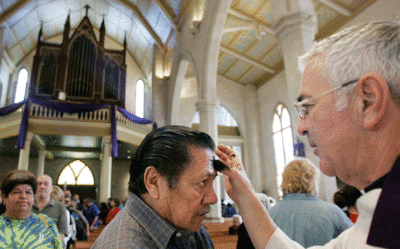 Father Craig Forner, right, marks a parishioner with an ash cross on his forehead during an Ash Wednesday service at San Fernando Cathedral in San Antonio,Texas ib Wednesday, Feb. 21, 2007. In the western Christian calendar, Ash Wednesday marks the start of Lent.