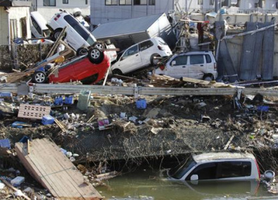 Displaced vehicles are seen at Sendai Port in Sendai, northeastern Japan, Saturday, March 12, 2011, following Friday's 8.9-magnitude quake and the tsunami it spawned hit the country's northeastern coast.