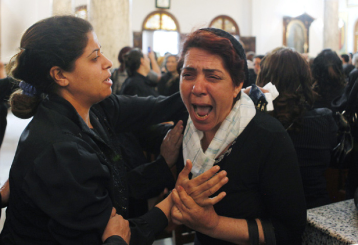 A Coptic Christian woman grieves during the funeral for victims of Saturday's clashes between Muslims and Christians in Cairo May 8, 2011. Egypt's military rulers vowed on Sunday to crack down on religious violence after 12 people died in clashes in a Cairo suburb sparked by unconfirmed suspicions that Christians had abducted a woman who converted to Islam.