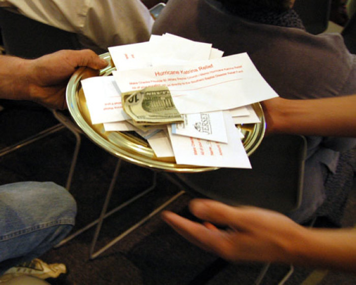 In this file photo, a collection plate containing envelopes specifically for the victims of hurricane Katrina is passed during church service, at the Jersey Baptist Church in Pataskala, Ohio, Sunday Sept. 4, 2005.