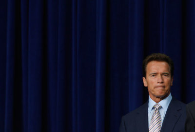 In this file photo, then California Governor Arnold Schwarzenegger attends an event in the Eisenhower Executive Office building in Washington, October 30, 2009.