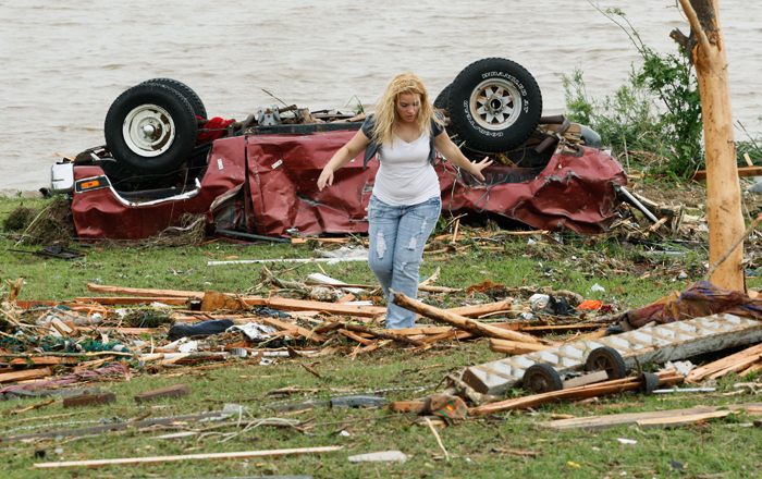 A woman participates in the search for missing children after a tornado ripped through the Falcon Lake area of Piedmont, Oklahoma May 24, 2011. Several tornadoes touched down in Oklahoma on Tuesday afternoon, the largest one striking El Reno, west of Oklahoma City, and continuing to the northeast, the National Weather Service said.