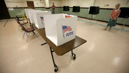 In this file photo, election workers await voters during a lull at a polling station at Sleepy Hollow Elementary School in Falls Church, Virginia, November 4, 2008.