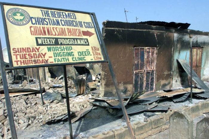 This file photo shows a sign pointing towards a church burned down by riots in northern Nigeria.