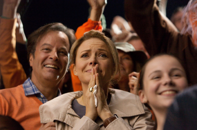 Jody McFarland, played by actress Faith Ford, watches a school football game where her son Tyler McFarland (Tony Oller) is the star quarterback.