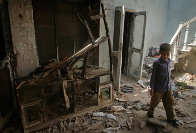 A boy walks through the rubble of a damaged house which was previously set on fire in Punjab province April 19, 2011. Residents of the neighbourhood, known as Christian Colony, in the town in Punjab province, are haunted by memories of a 2009 attack by a Muslim mob in which seven members of a family were killed and dozens of houses torched. Picture taken on April 19, 2011.