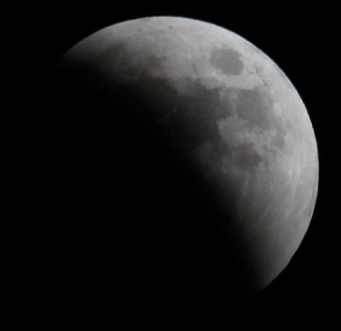 A shadow falls on the moon as it undergoes a total lunar eclipse as seen from Jerusalem June 15, 2011.