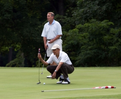 President Barack Obama lines up his putt as he plays a round of golf with House Speaker John Boehner, background, Vice President Joe Biden and Ohio Gov. John Kasich at the Courses at Andrews at Joint Base Andrews, Maryland, Saturday, June 18, 2011.