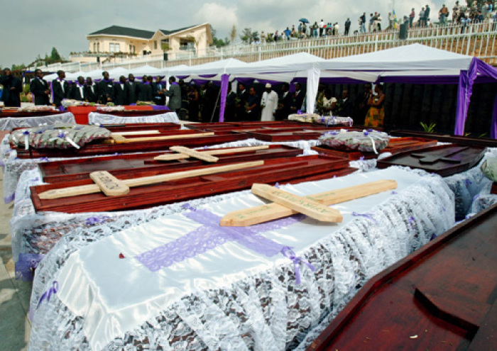 Coffins of people killed during Rwanda's 1994 genocide are buried at Gisozi memorial in Kigali April 7, 2004.