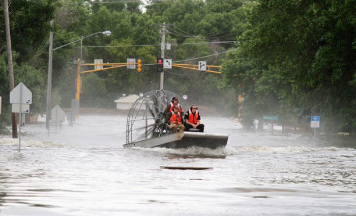 Law enforcement personnel and State Fish and Games agents use an air boat to search a neighborhood for any remaining persons, in Minot, North Dakota, June 24, 2011. Federal officials sharply increased plans to release more water on the swollen Souris River Thursday, adding up to three feet to the expected peak of flooding at Minot, North Dakota, where thousands of homes already have been evacuated.