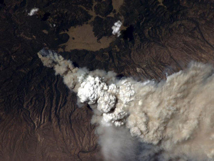 A crew member aboard the International Space Station, flying at an altitude of approximately 235 statute miles on June 27, 2011, exposed this still photograph of a major fire in the Jemez Mountains of the Santa Fe National Forest in north-central New Mexico near Los Alamos.