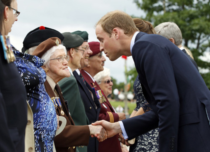 Britain's Prince William greets war veterans after a ceremony at the National War Memorial in Ottawa June 30, 2011.