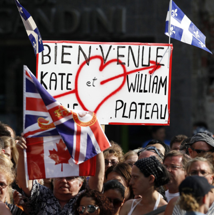 Spectators wait for the arrival of Britain's Prince William and his wife Catherine, Duchess of Cambridge, at the Institut de tourisme et d'hotellerie du Quebec in Montreal July 2, 2011. Prince William and his wife Catherine, Duchess of Cambridge, are on a royal tour of Canada from June 30 to July 8.