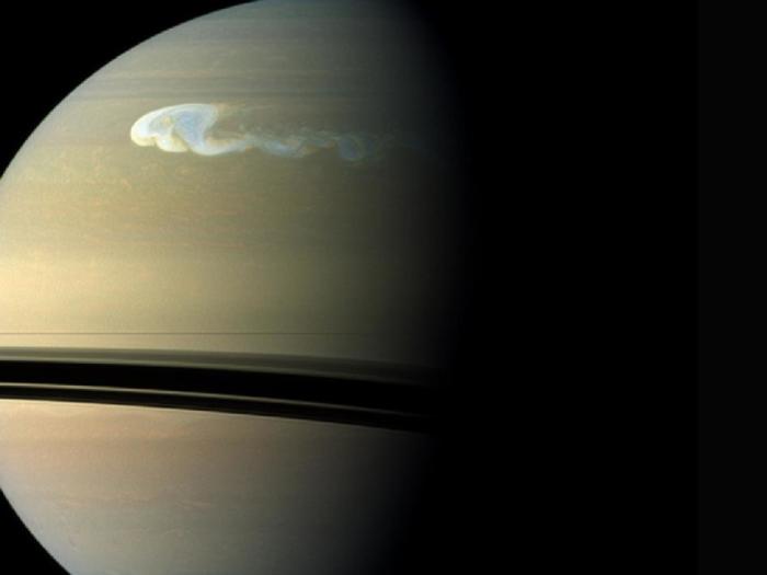 The huge storm churning through the atmosphere in Saturn's northern hemisphere overtakes itself as it encircles the planet in this true-color view from NASA's Cassini spacecraft.
