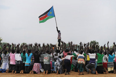A man holds up South Sudan's flag