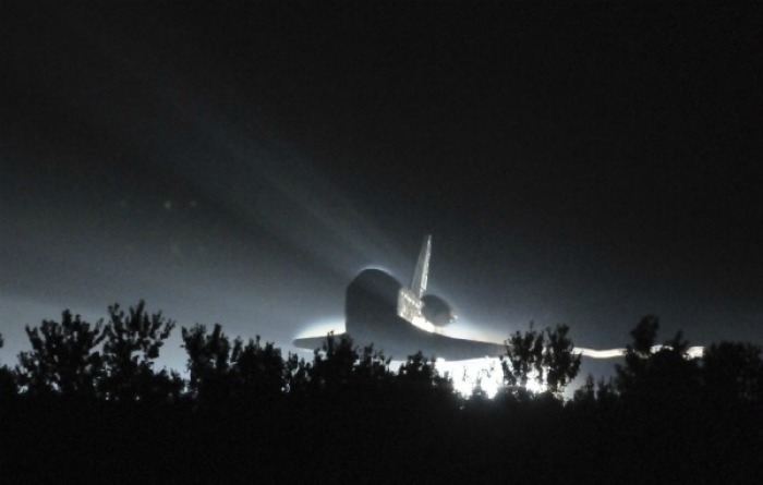 The space shuttle Atlantis makes a night landing at the Kennedy Space Center in Florida.