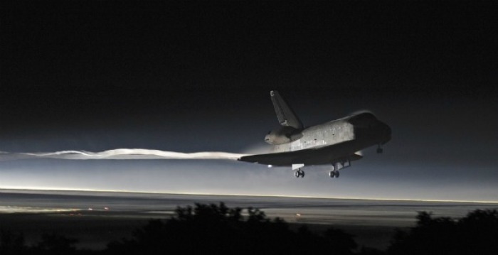 Space shuttle Atlantis lands at the Kennedy Space Center in Cape Canaveral, Florida, July 21, 2011. The space shuttle Atlantis glided home through a moonlit sky for its final landing at the Kennedy Space Center in Florida on Thursday, completing a 30-year odyssey for NASA's shuttle fleet.